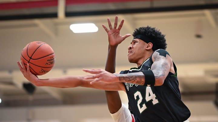 Wauwatosa West guard Jalen Brown (24) puts up a shot against Wauwatosa East in a game Friday, December 12, 2025, at Wauwatosa East High School in Wauwatosa, Wisconsin. West won 74-63.