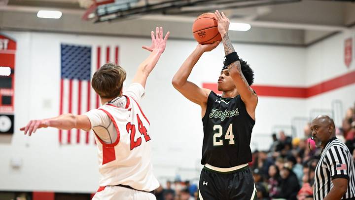 Wauwatosa West guard Jalen Brown shoots the ball over Wauwatosa East guard Parker Mitchellin a game Friday, December 12, 2025, at Wauwatosa East High School in Wauwatosa, Wisconsin. West won 74-63.