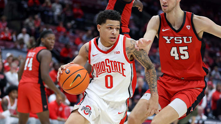 Nov 11, 2024; Columbus, Ohio, USA;  Ohio State Buckeyes guard John Mobley Jr. (0) drives past Youngstown State Penguins center Gabe Dynes (45) during the second half at Value City Arena. Mandatory Credit: Joseph Maiorana-Imagn Images