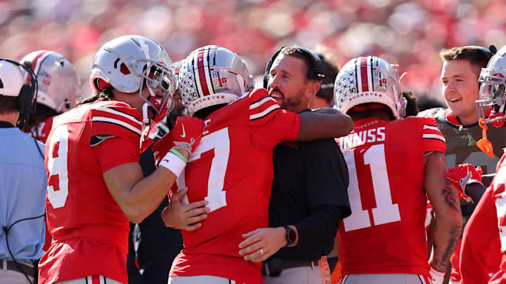 Oct 26, 2024; Columbus, Ohio, USA; Ohio State Buckeyes wide receiver Carnell Tate (17) celebrates a touchdown with Ohio State coach Brian Hartline during the first quarter against the Nebraska Cornhuskers at Ohio Stadium. Mandatory Credit: Joseph Maiorana-Imagn Images