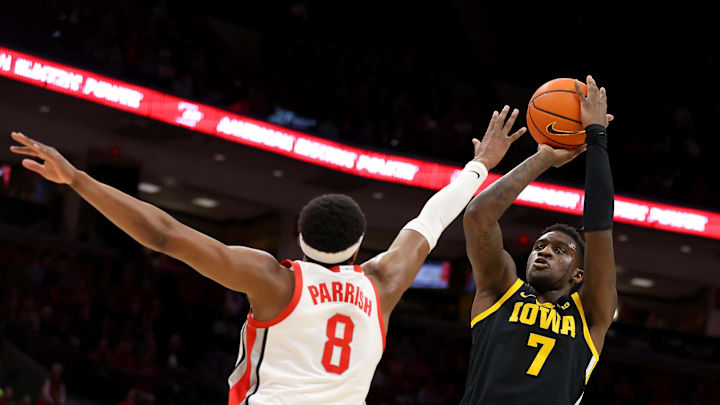 Jan 27, 2025; Columbus, Ohio, USA;  Iowa Hawkeyes forward Seydou Traore (7) shoots the ball as Ohio State Buckeyes guard Micah Parrish (8) defends during the first half at Value City Arena. Mandatory Credit: Joseph Maiorana-Imagn Images