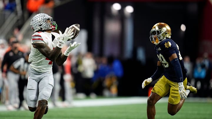 Ohio State Buckeyes wide receiver Jeremiah Smith (4) makes a catch against Notre Dame Fighting Irish cornerback Christian Gray (29) in the fourth quarter during the College Football Playoff National Championship at Mercedes-Benz Stadium in Atlanta on January 20, 2025.