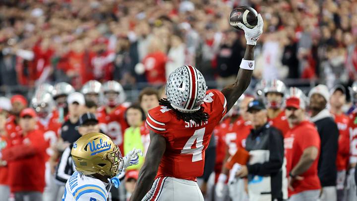 Nov 15, 2025; Columbus, Ohio, USA;  Ohio State Buckeyes wide receiver Jeremiah Smith (4) makes a one handed first down catch as UCLA Bruins defensive back Andre Jordan Jr. (2) defends during the first quarter at Ohio Stadium. Mandatory Credit: Joseph Maiorana-Imagn Images