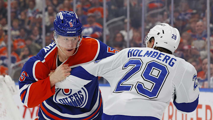Mar 21, 2026; Edmonton, Alberta, CAN; Edmonton Oilers defensemen Connor Murphy (5) and Tampa Bay Lightning forward Pontus Holmberg (29) fight during the second period at Rogers Place. Mandatory Credit: Perry Nelson-Imagn Images