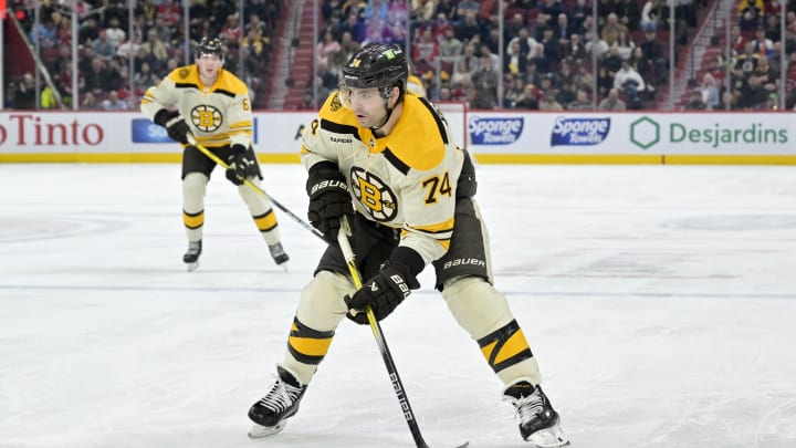 Mar 14, 2024; Montreal, Quebec, CAN; Boston Bruins forward Jake DeBrusk (74) plays the puck during the third period of the game against the Montreal Canadiens at the Bell Centre. Mandatory Credit: Eric Bolte-USA TODAY Sports