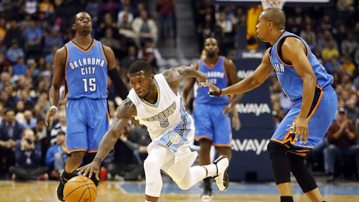 Nov 19, 2014; Denver, CO, USA; Denver Nuggets guard Nate Robinson (5) picks up a loose ball during the first half against the Oklahoma City Thunder at Pepsi Center. Mandatory Credit: Chris Humphreys-Imagn Images
