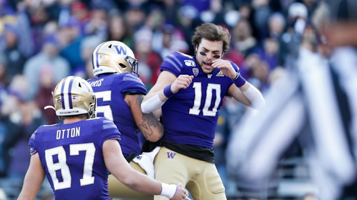 Nov 29, 2019; Seattle, WA, USA; Washington Huskies quarterback Jacob Eason (10) celebrates his three-yard touchdown run against the Washington State Cougars during the first quarter at Husky Stadium. Mandatory Credit: Jennifer Buchanan-Imagn Images