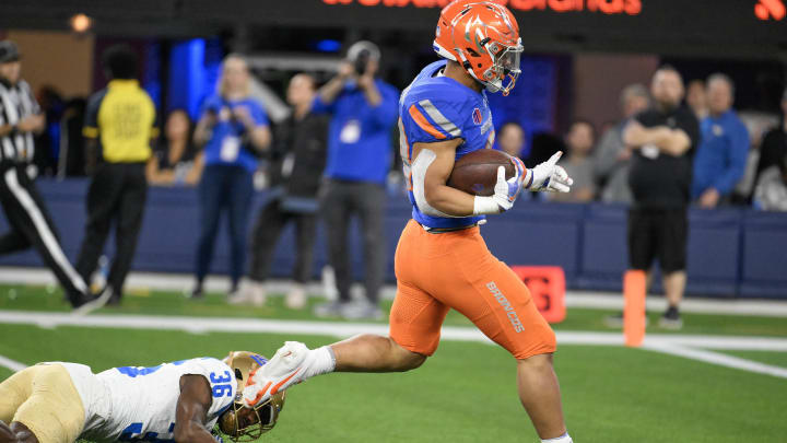 Dec 16, 2023; Inglewood, CA, USA; Boise State Broncos running back George Holani (24) runs past UCLA Bruins defensive back Alex Johnson (36) during the fourth quarter of the Starco Brands LA Bowl at SoFi Stadium. Mandatory Credit: Robert Hanashiro-USA TODAY Sports