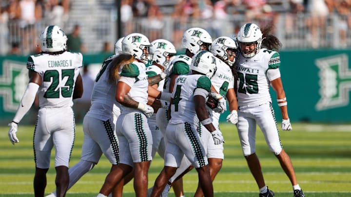 Aug 23, 2025; Honolulu, Hawaii, USA;  The Hawaii Rainbow Warriors reacts with Hawaii Rainbow Warriors defensive back Kilinahe Mendiola-Jensen (8) after he made an interception against the Stanford Cardinal during the second half at Clarence T.C. Ching Athletics Complex. Mandatory Credit: Marco Garcia-Imagn Images
