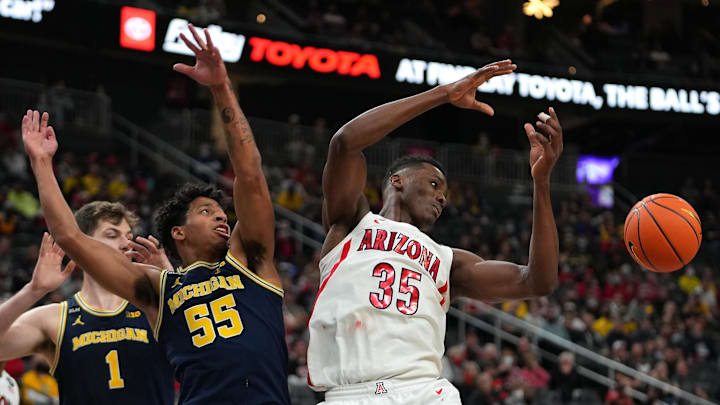 Nov 21, 2021; Las Vegas, Nevada, USA;Michigan Wolverines guard Eli Brooks (55) and Arizona Wildcats center Christian Koloko (35) reach for a deflected ball during the second half at T-Mobile Arena. Mandatory Credit: Stephen R. Sylvanie-Imagn Images