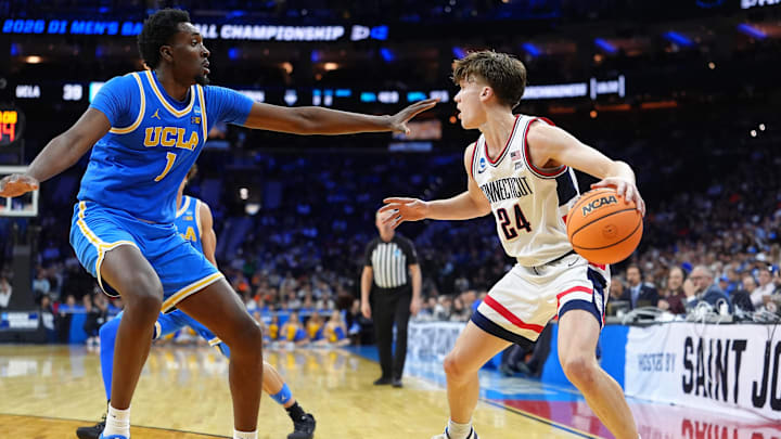 Mar 22, 2026; Philadelphia, PA, USA; UConn Huskies guard Braylon Mullins (24) dribbles the ball against UCLA Bruins center Xavier Booker (1) in the second half during a second round game of the men's 2026 NCAA Tournament at Xfinity Mobile Arena. Mandatory Credit: Kyle Ross-Imagn Images