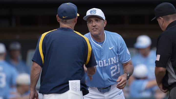 Jun 8, 2024; Chapel Hill, NC, USA; North Carolina Tar Heels head coach Scott Forbes (21) shakes hands with West Virginia Mountaineers Randy Mazey prior to the DI Baseball Super Regional at Boshamer Stadium. Mandatory Credit: Jeffrey Camarati-USA TODAY Sports

