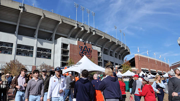 Nov 25, 2023; Auburn, Alabama, USA;  Auburn Tiger and Alabama Crimson Tide fans gather outside Jordan-Hare Stadium before the game between Auburn and Alabama. Mandatory Credit: John Reed-Imagn Images