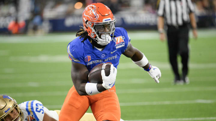 Dec 16, 2023; Inglewood, CA, USA; Boise State Broncos running back Ashton Jeanty (2) slips a tackle by UCLA Bruins linebacker Darius Muasau (53) during the first quarter of the Starco Brands LA Bowl at SoFi Stadium. Mandatory Credit: Robert Hanashiro-USA TODAY Sports