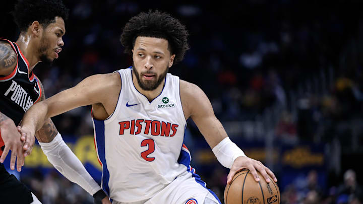 Jan 6, 2025; Detroit, Michigan, USA;  Detroit Pistons guard Cade Cunningham (2) drives past Portland Trail Blazers guard Anfernee Simons (1) in the fourth quarter at Little Caesars Arena. Mandatory Credit: Lon Horwedel-Imagn Images