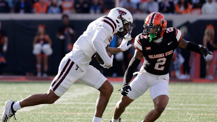 Texas Tech's Josh Kelly runs the ball against Oklahoma State's Korie Black during an NCAA football game on Saturday, Nov. 23, 2024, in Stillwater, Okla.
