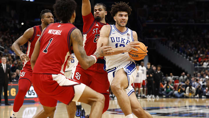Mar 27, 2026; Washington, DC, USA; Duke Blue Devils forward Cameron Boozer (12) dribbles the ball past St. John's Red Storm forward Zuby Ejiofor (24) in the first half during a Sweet Sixteen game of the East Regional of the men's 2026 NCAA Tournament at Capital One Arena. Mandatory Credit: Amber Searls-Imagn Images