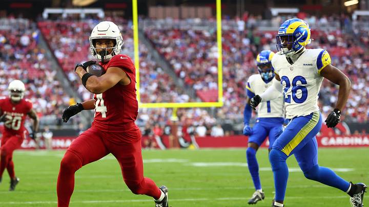 Dec 7, 2025; Glendale, Arizona, USA; Arizona Cardinals wide receiver Michael Wilson (14) runs for a touchdown after a catch against Los Angeles Rams safety Kamren Kinchens (26) during the first half at State Farm Stadium. Mandatory Credit: Mark J. Rebilas-Imagn Images