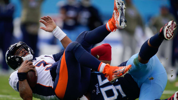 Tennessee Titans defensive end DeMarcus Walker (95) sacks Denver Broncos quarterback Russell Wilson.