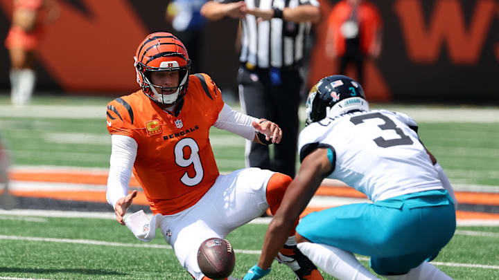 Sep 14, 2025; Cincinnati, Ohio, USA;  Cincinnati Bengals quarterback Joe Burrow (9) goes for the loose ball with Jacksonville Jaguars cornerback Tyson Campbell (3) during the first quarter at Paycor Stadium. Mandatory Credit: Joseph Maiorana-Imagn Images