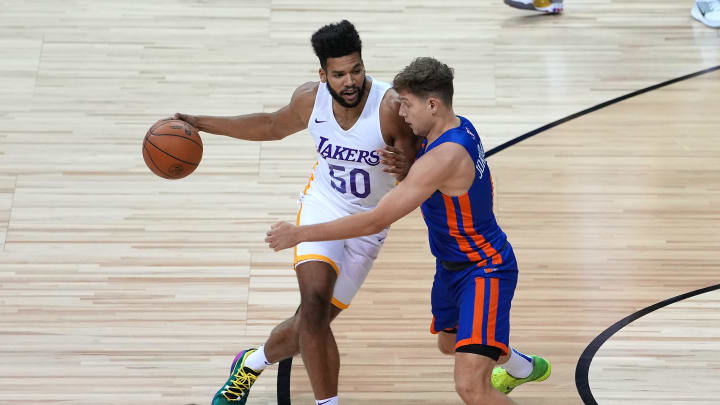 Aug 11, 2021; Las Vegas, Nevada, USA; Los Angeles Lakers forward Yoeli Childs (50) dribbles against New York Knicks guard Rokas Jokubaitis (0) during an NBA Summer League game at Thomas & Mack Center. Mandatory Credit: Stephen R. Sylvanie-USA TODAY Sports