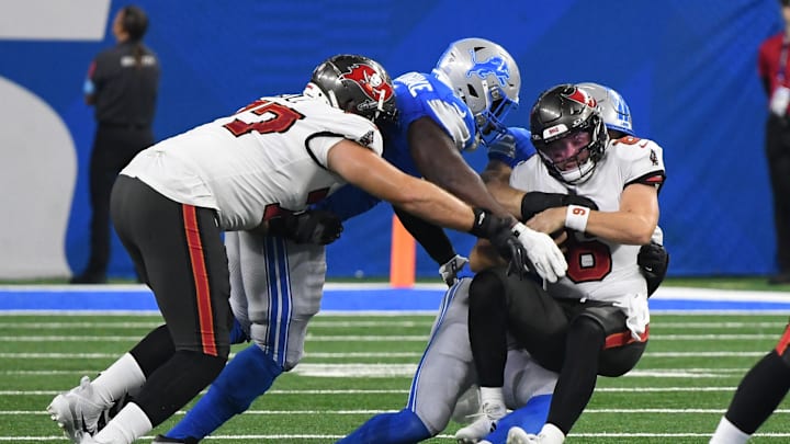 Tampa Bay Buccaneers quarterback Baker Mayfield (6) gets sacked by Detroit Lions defensive ends Levi Onwuzurike (91) and Aidan Hutchinson (97).