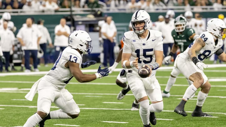 Penn State quarterback Drew Allar hands off to running back Kaytron Allen against Michigan State at Ford Field.
