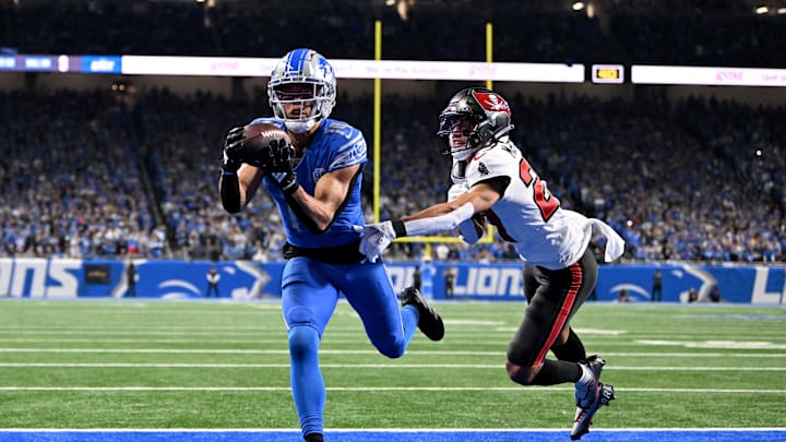 Jan 21, 2024; Detroit, Michigan, USA; Detroit Lions wide receiver Amon-Ra St. Brown (14) makes a catch for a touchdown against Tampa Bay Buccaneers cornerback Zyon McCollum (27) during the second half in a 2024 NFC divisional round game at Ford Field. 