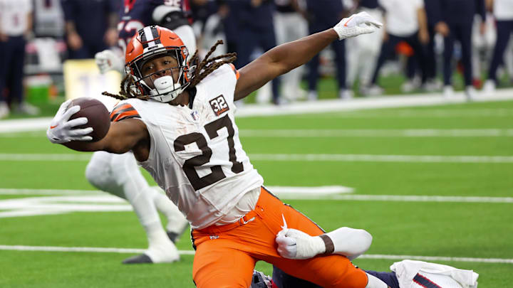 Jan 13, 2024; Houston, Texas, USA; Cleveland Browns running back Kareem Hunt (27) breaks the tackle of Houston Texans linebacker Christian Harris (48) as he scores a touchdown in a 2024 AFC wild card game at NRG Stadium. Mandatory Credit: Thomas Shea-Imagn Images