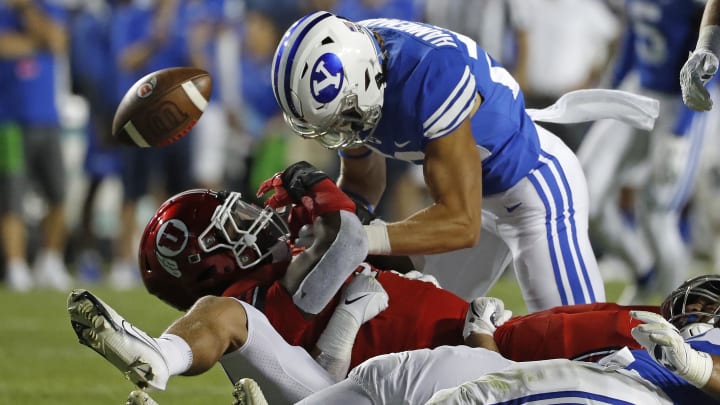 Sep 11, 2021; Provo, Utah, USA; Utah Utes running back Tavion Thomas (9) is stopped by Brigham Young Cougars linebacker Keenan Pili (41) defensive back Ammon Hannemann (22) in the third quarter at LaVell Edwards Stadium.