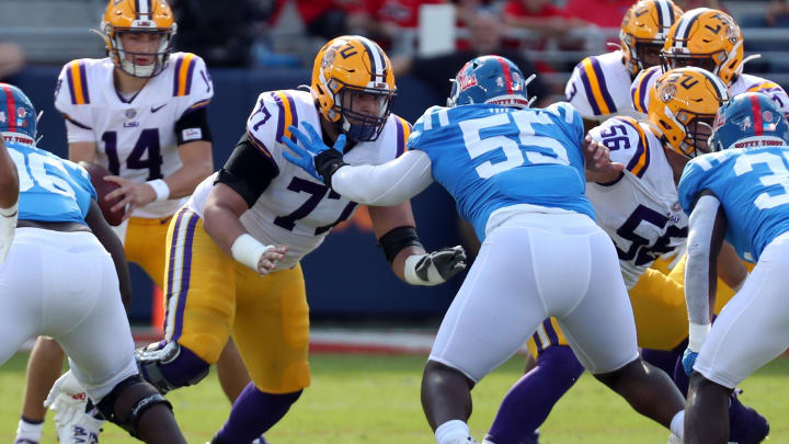 Oct 23, 2021; Oxford, Mississippi, USA; LSU Tigers offensive linemen Marlon Martinez (77) blocks Mississippi Rebels defensive linemen KD Hill (55) during the first half at Vaught-Hemingway Stadium. Mandatory Credit: Petre Thomas-USA TODAY Sports