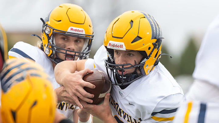 Hudsonville's Griffin Baker (left) hands off to Bryce Fox during a victory over Howell Saturday, Nov. 16, 2024. Hudsonville's Griffin Baker (left) hands off to Bryce Fox during a victory over Howell Saturday, Nov. 16, 2024.