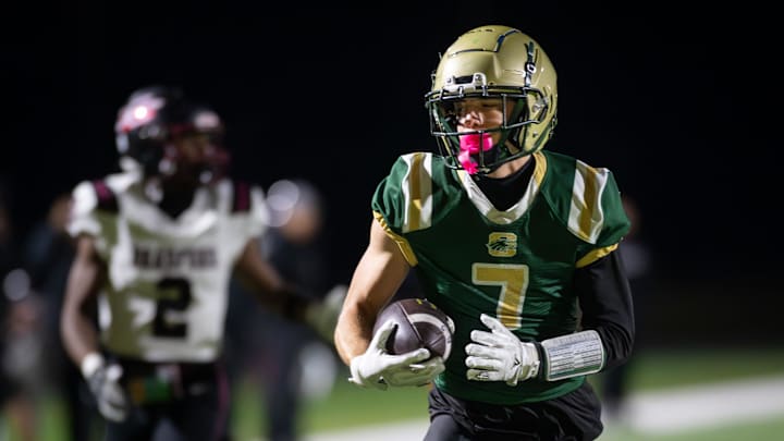Racine Case wide receiver Zachary DeBaker (7) outraces Kenosha Bradford defensive back Larenzz Pratt (2) for a touchdown in a Level 1 playoff game Friday, October 24, 2025, at Case High School in Racine, Wisconsin.