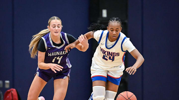 Wisconsin Lutheran's Londyn Hollins (24) outraces Waunakee guard Ashlyn Bauer (14) to a loose ball in a game in the Kettle Moraine Thanksgiving Classic on Friday, November 28, 2025, at the Kettle Moraine High School in Wales, Wisconsin.