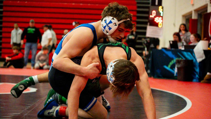 Highland’s Austin Bickerton, black and green, wrestles Detroit Central Catholic’s Ryan Totten during the Wadsworth Grizzly Invitational high school wrestling tournament, Jan. 24, 2026, at Wadsworth High School in Wadsworth, Ohio.