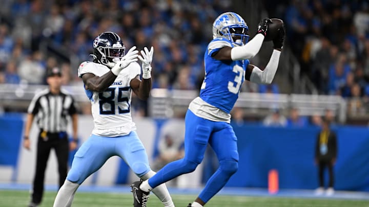 Oct 27, 2024; Detroit, Michigan, USA; Detroit Lions safety Kerby Joseph (31) steps in front of Tennessee Titans tight end Chig Okonkwo (85) to intercept the ball in the second quarter at Ford Field. Mandatory Credit: Lon Horwedel-Imagn Images