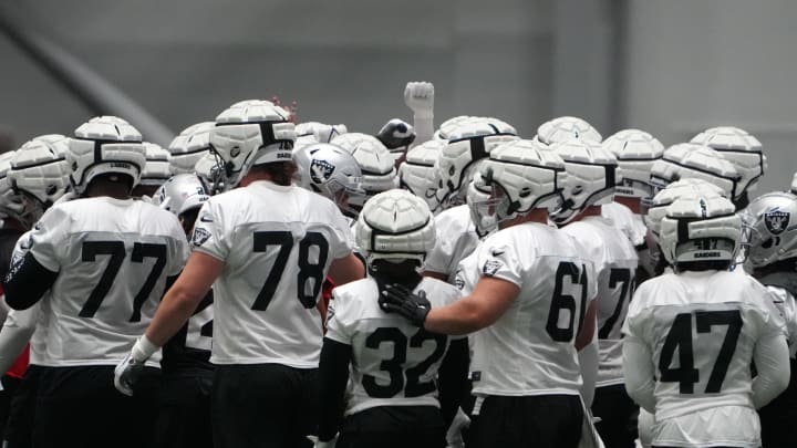 Jul 31, 2023; Henderson, NV, USA; Las Vegas Raiders wearing Guardian helmet caps huddle during training camp at the Intermountain Health Performance Center. Mandatory Credit: Kirby Lee-USA TODAY Sports