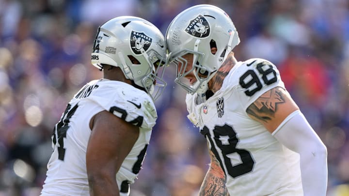 Sep 15, 2024; Baltimore, Maryland, USA; Las Vegas Raiders defensive tackle Christian Wilkins (94) and defensive end Maxx Crosby (98) celebrate after a sack during the second half against the Baltimore Ravens at M&T Bank Stadium. Mandatory Credit: Reggie Hildred-Imagn Images