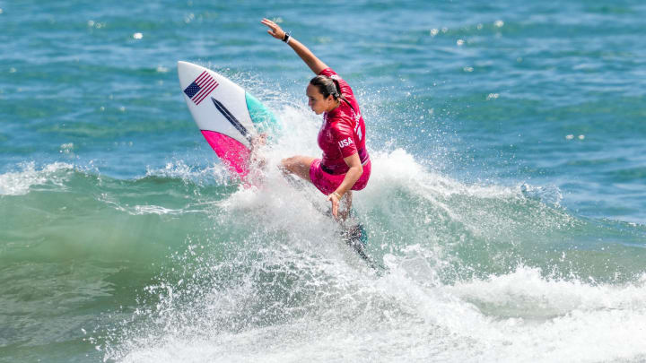 Jul 25, 2021; Tokyo, Japan; Carissa Moore (USA) surfs in women   s round 1 competition during the Tokyo 2020 Olympic Summer Games at Tsurigasaki Surfing Beach.