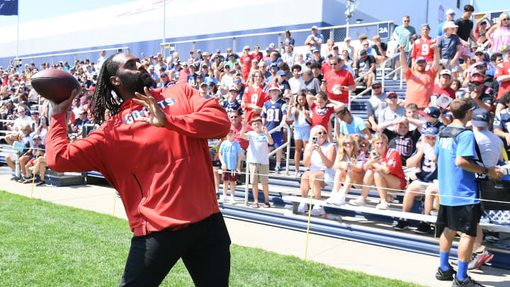 Jul 26, 2024; Foxborough, MA, USA; New England Patriots linebacker Matthew Judon (9) tosses a ball to fans during training camp at Gillette Stadium. Mandatory Credit: Eric Canha-USA TODAY Sports