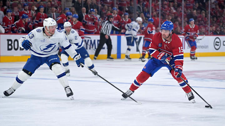 Apr 24, 2026; Montreal, Quebec, CAN; Montreal Canadiens forward Alex Newhook (15) plays the puck and Tampa Bay Lightning defenseman Darren Raddysh (43) defends during the third period in game three of the first round of the 2026 Stanley Cup Playoffs at the Bell Centre. Mandatory Credit: Eric Bolte-Imagn Images
