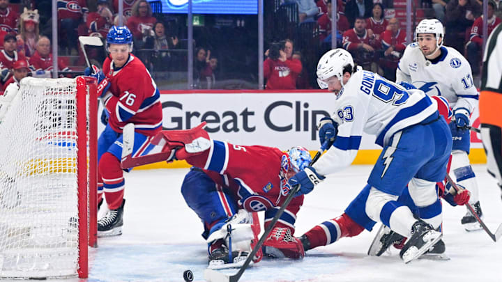 May 1, 2026; Montreal, Quebec, CAN; Tampa Bay Lightning forward Gage Goncalves (93) scores the winning  goal against Montreal Canadiens goalie Jakub Dobes (75) during the overtime period in game six of the first round of the 2026 Stanley Cup Playoffs at the Bell Centre. Mandatory Credit: Eric Bolte-Imagn Images
