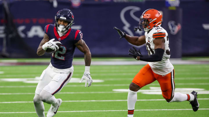 Jan 13, 2024; Houston, Texas, USA; Houston Texans wide receiver Nico Collins (12) runs after his reception against Cleveland Browns safety Duron Harmon (30) in a 2024 AFC wild card game at NRG Stadium. Mandatory Credit: Thomas Shea-USA TODAY Sports