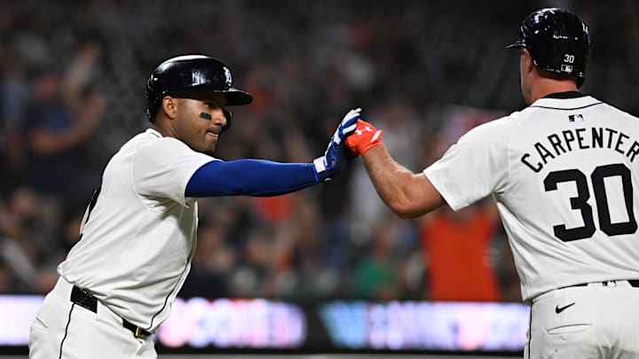 Sep 10, 2024; Detroit, Michigan, USA; Detroit Tigers designated hitter Kerry Carpenter (30) celebrates with Detroit Tigers first baseman Andy Ibanez (77) after scoring a run against the Colorado Rockies in the sixth inning at Comerica Park.