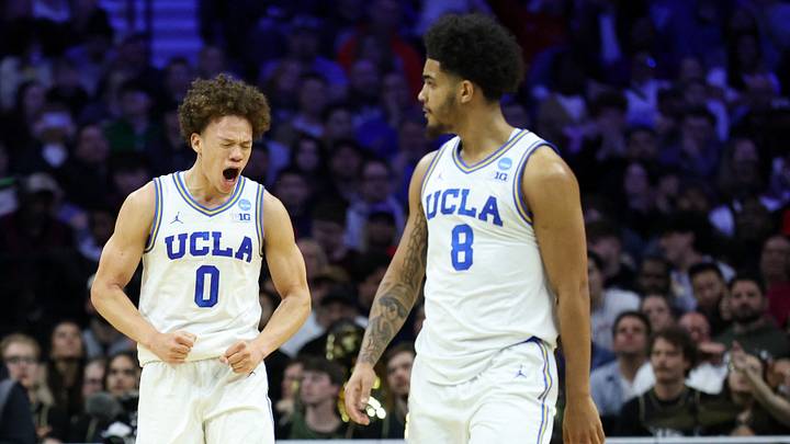 Mar 20, 2026; Philadelphia, PA, USA; UCLA Bruins guard Trent Perry (0) reacts with guard Eric Freeny (8) in the second half during a first round game of the men's 2026 NCAA Tournament at Xfinity Mobile Arena. Mandatory Credit: Bill Streicher-Imagn Images