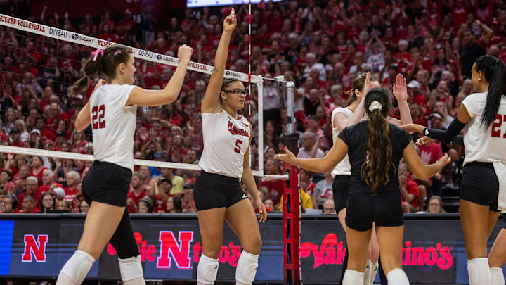 Nebraska volleyball players celebrate a point against Stanford at the Bob Devaney Sports Center.