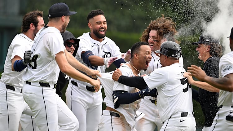 Jul 14, 2024; Detroit, Michigan, USA;  Detroit Tigers right fielder Wenceel Pérez (46) celebrates with teammates after his bunt scored the game-winning run against the Los Angeles Dodgers in the ninth inning at Comerica Park. Mandatory Credit: Lon Horwedel-USA TODAY Sports