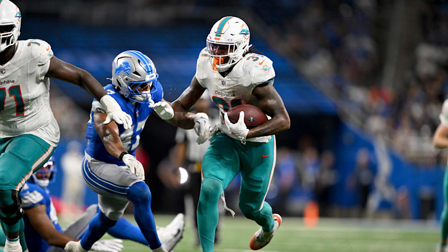 Miami Dolphins running back Ollie Gordon II (31) runs the ball against the Detroit Lions against the Miami Dolphins in the fourth quarter at Ford Field on Saturday. | Lon Horwedel-Imagn Images