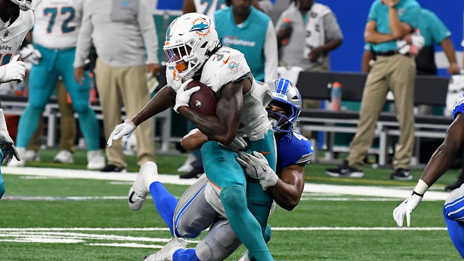 Miami Dolphins running back Ollie Gordon II (31) gets tackled by Detroit Lions linebacker Ezekiel Turner (47) in the fourth quarter at Ford Field.  | Eamon Horwedel-Imagn Images