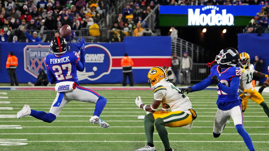 Dec 11, 2023; East Rutherford, New Jersey, USA; New York Giants safety Jason Pinnock (27) makes an interception during the second quarter against the Green Bay Packers at MetLife Stadium.   | Robert Deutsch-USA TODAY Sports